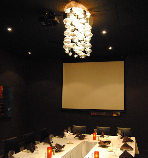 Gilardi Room set up with a large projector screen for presentations and watch parties