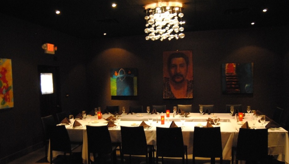 Gilardi private dining room set with linens, glassware, and warm lighting